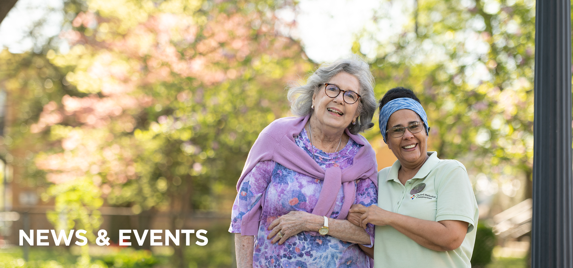 UMCF news and evnets new A Collingswood resident with a sweater thrown over her shoulders strolls outside, arm in arm with a teammate dressed in a UMC polo shirt.