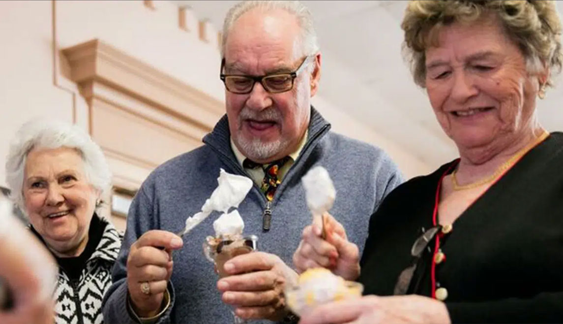 UMC residents frosting cupcakes inside their senior living community.